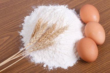 Prepare ingredients for baking. Flour, egg on a table. clipart