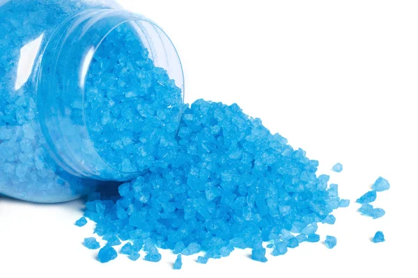 Blue bath salt spilled out of a glass jar isolated on white — Stock Photo, Image
