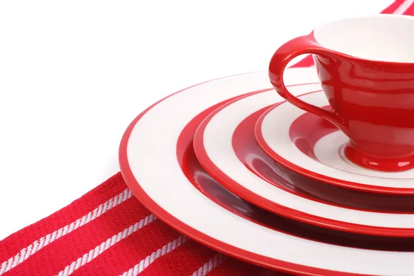 Table setting. Red crockery for striped napkin isolated — Stock Photo, Image