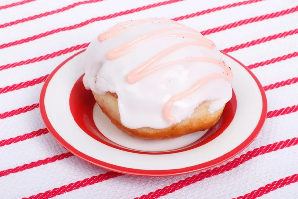 Donut glaze on a striped tablecloth — Stock Photo, Image