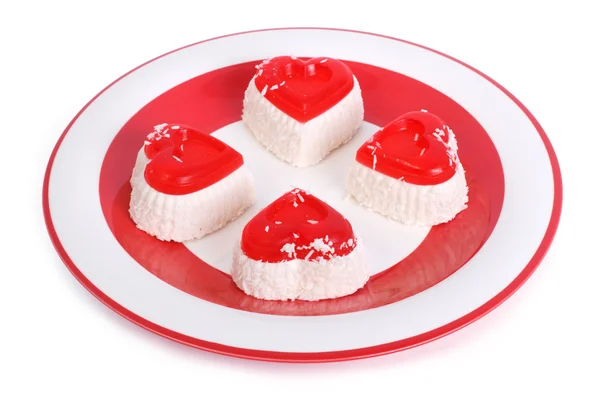 Slavnostní tvarohové dortíky izolovaných na bílém na červenou desku — Stock fotografie