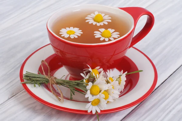 Chamomile tea on a wooden table. Tableware — Stock Photo, Image