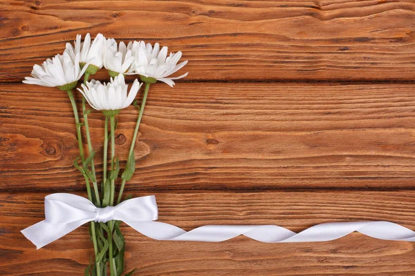 Ramo de flores de manzanilla con lazo blanco — Foto de Stock