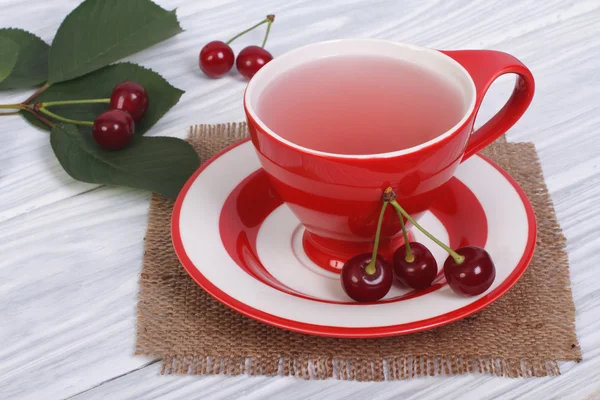 Ripe red cherries and fruit tea — Stock Photo, Image