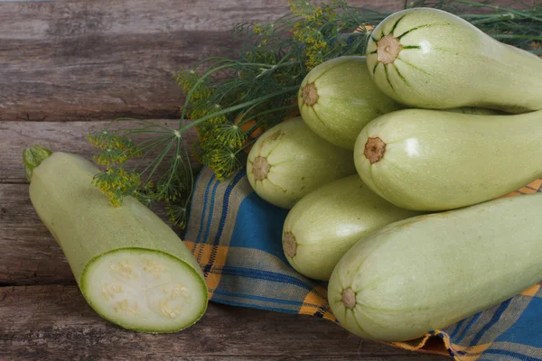 Fresh sliced squash and fennel on a napkin on a wooden table — Stock Photo, Image
