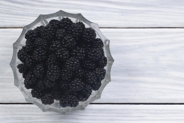 Ripe blackberries in a glass bowl, top view. — Stock Photo, Image