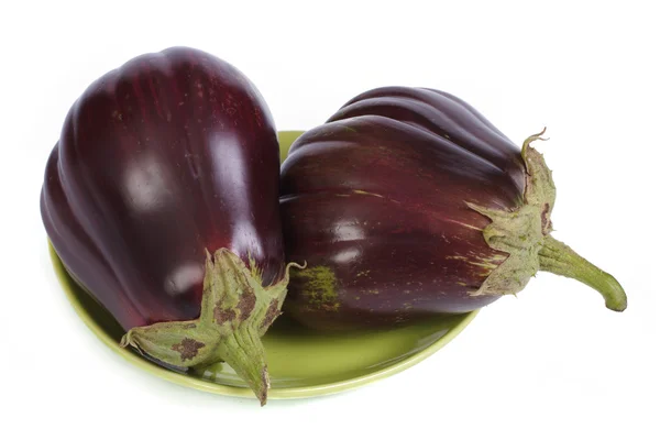 Two eggplant on green plate isolated on white background — Stock Photo, Image