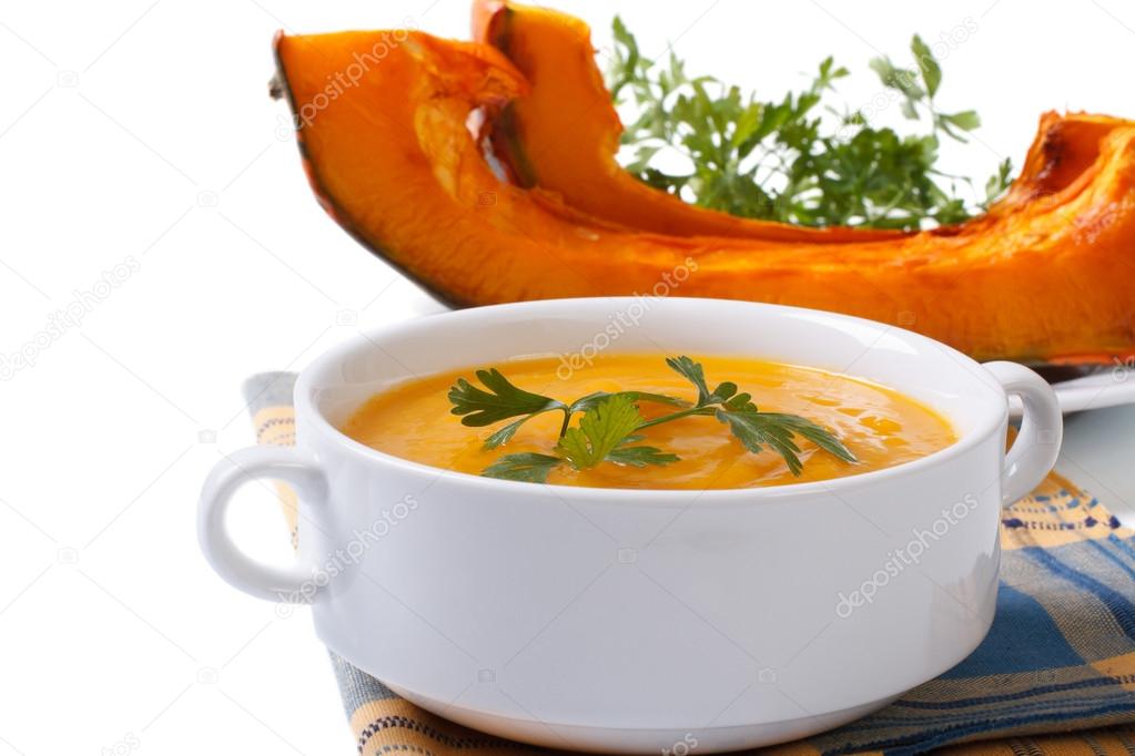 Soup with baked pumpkin and parsley isolated on white background