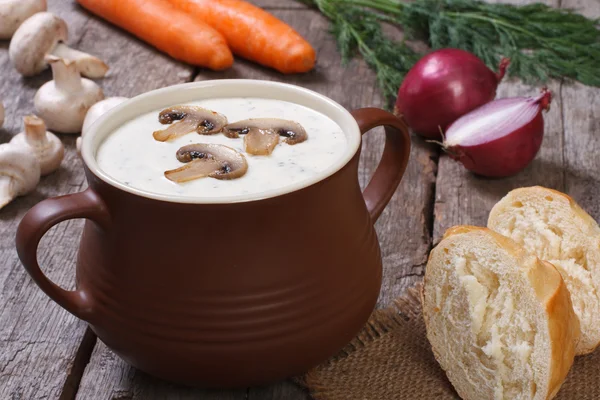 Mushroom soup in a pot and ingredients on an old table — Stock Photo, Image