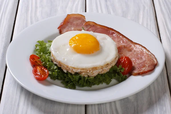 Fried egg with bacon and rice cakes — Stock Photo, Image