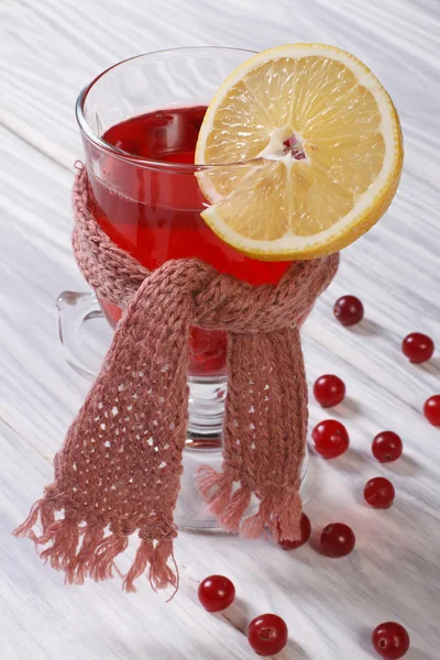 Hot drink with lemon cranberry scarf tied up — Stock Photo, Image