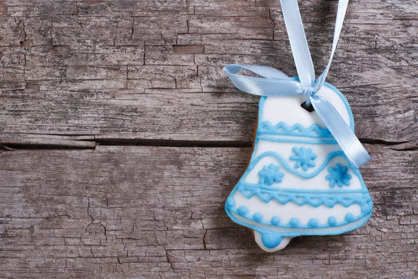Ginger biscuits. Christmas bell on a background of blue wooden board — Stock Photo, Image