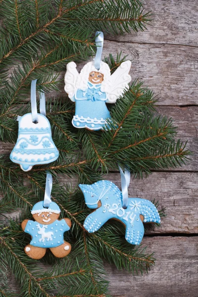 Blue gingerbread cookie on a Christmas tree. vertical — Stock Photo, Image