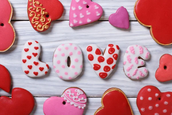 Gingerbread in the form of hearts and letters on a wooden — Stock Photo, Image