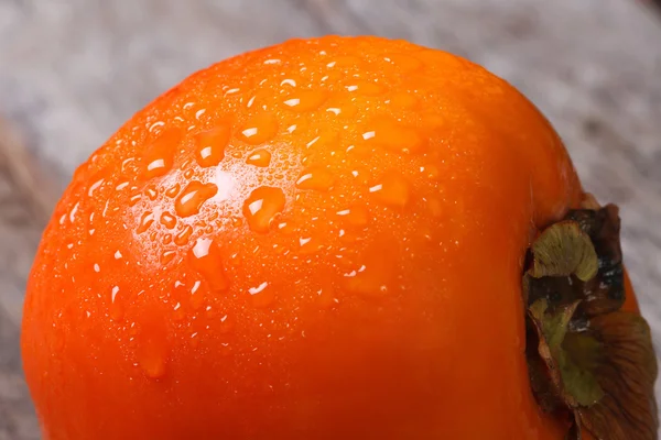 Persimmon close up with drops of water. macro. — Stock Photo, Image