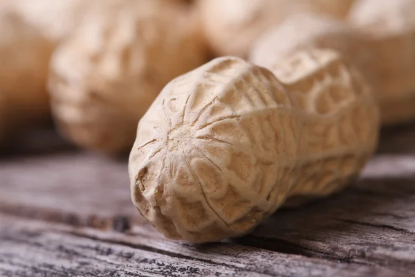 Peanuts in shell closeup on a wooden table — Stock Photo, Image