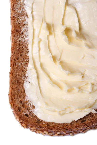 Pão integral com manteiga isolada em branco — Fotografia de Stock