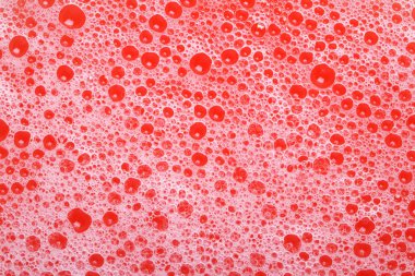 soap bubbles red background closeup. texture.