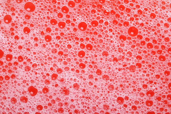 Bolle di sapone sfondo rosso primo piano. texture . — Foto Stock