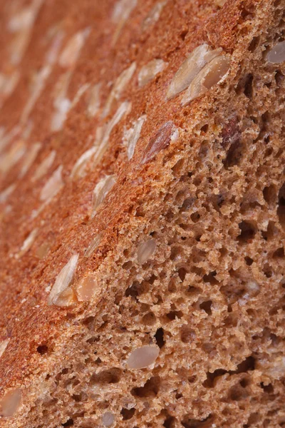 Bread with nuts, raisins and sunflower seeds and closeup — Stock Photo, Image