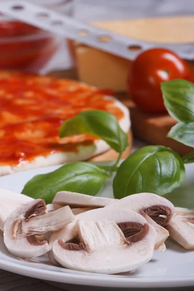 Preparation of ingredients for pizza: sliced ??mushrooms, basil — Stock Photo, Image