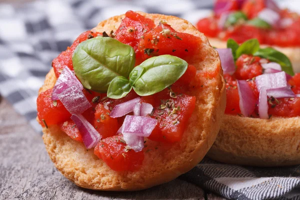 Two Italian bruschetta with tomato, onion and basil — Stock Photo, Image