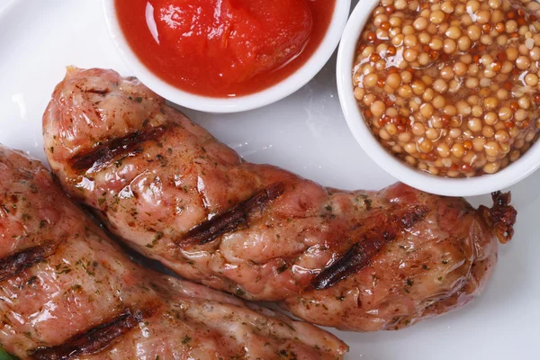 Two grilled hot sausages with ketchup and Dijon mustard — Stock Photo, Image