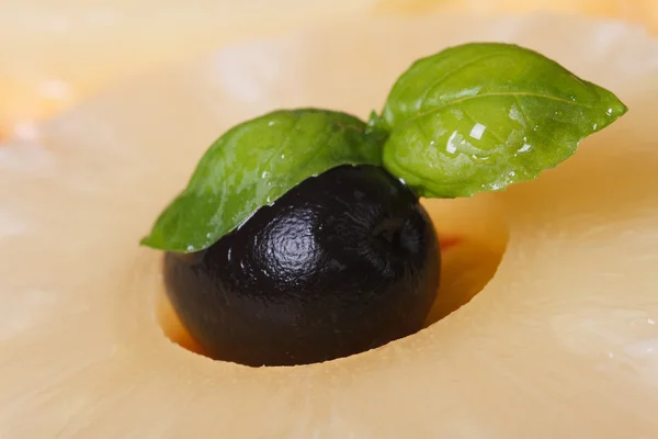 Olives and green basil in a ring of pineapple. macro — Stock Photo, Image