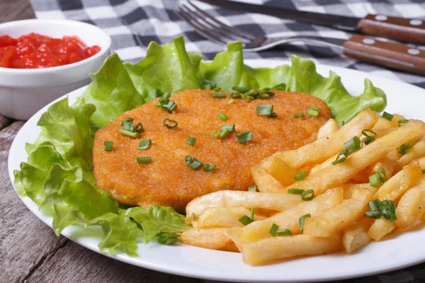 Schnitzel and fries with sauce closeup — Stock Photo, Image