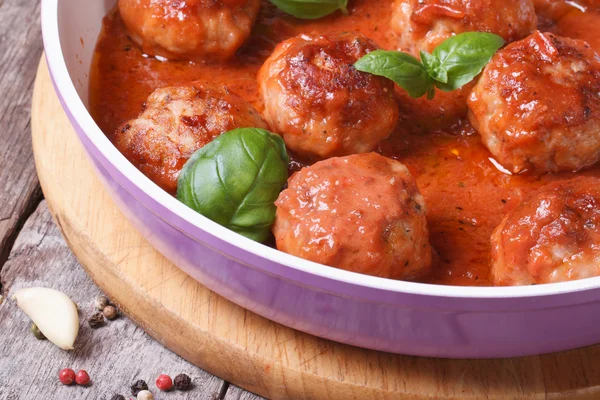 Meatballs with tomato sauce and basil in a pan macro — Stock Photo, Image