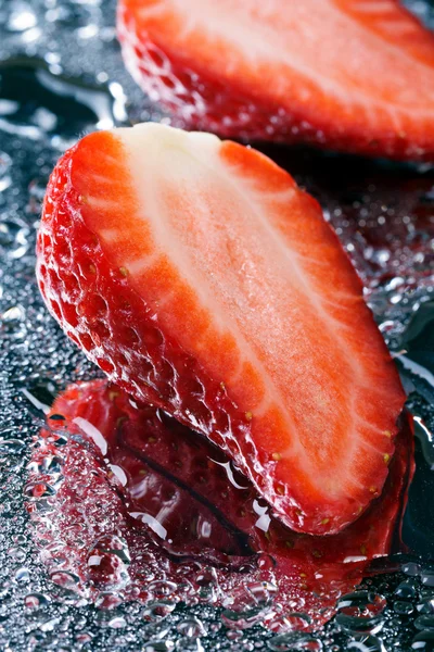 Two half fresh strawberries with water macro — Stock Photo, Image