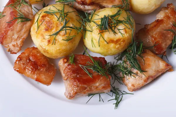 New potatoes and fried slices pork top view — Stock Photo, Image