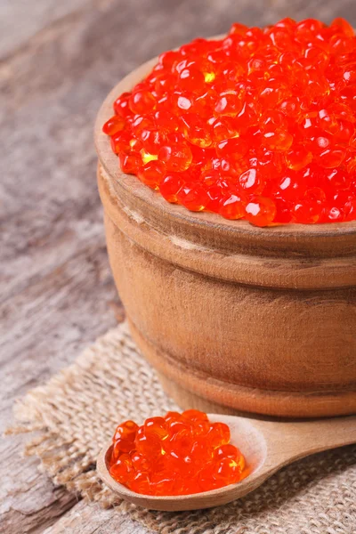 Red salmon caviar in a wooden spoon and a barrel — Stock Photo, Image