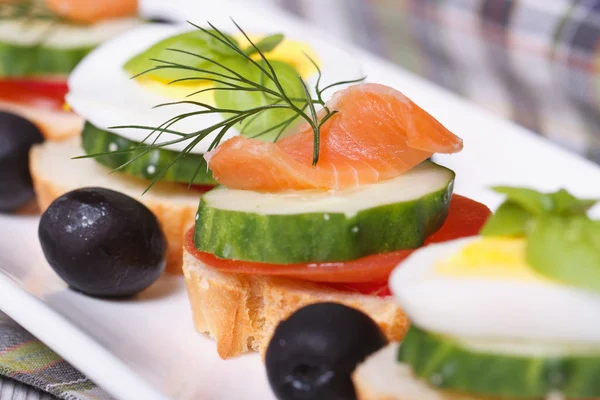 Canapes with salmon, cucumber, tomato and dill — Stock Photo, Image