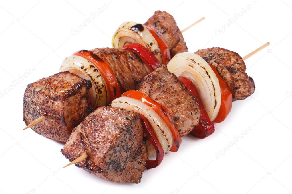 two skewers of meat with vegetables isolated on a white