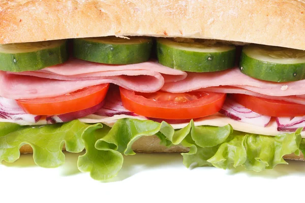 Ciabatta sandwich with ham and vegetables isolated close-up — Stock Photo, Image