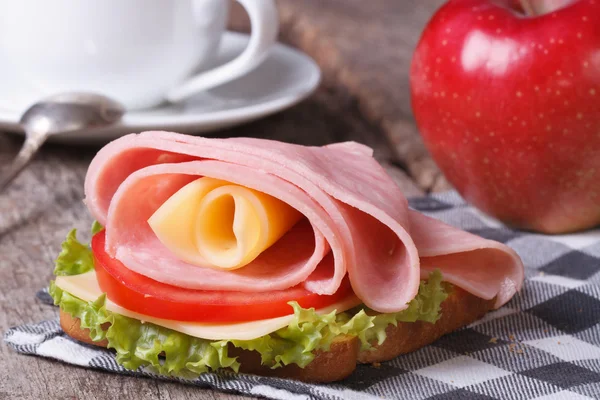 Beautiful sandwich with ham and cheese, coffee, red apple — Stock Photo, Image