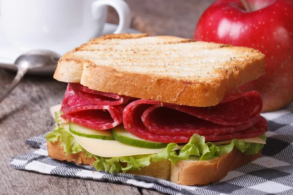 Breakfast: toast with salami, coffee, red apple — Stock Photo, Image
