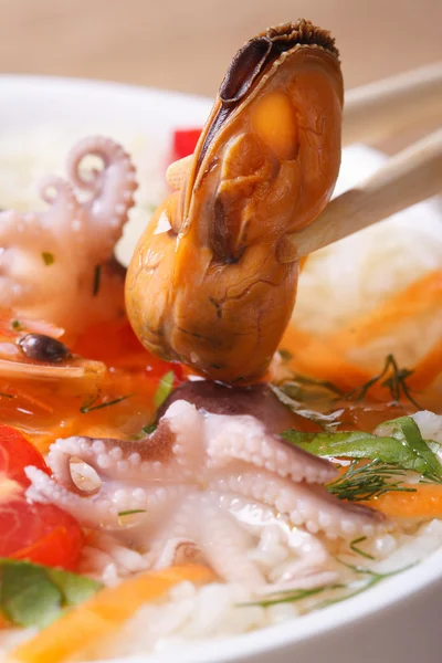 Mussel hold chopsticks close up vertical — Stock Photo, Image