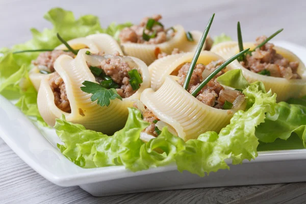 Pasta lumakoni stuffed meat and onion closeup — Stock Photo, Image