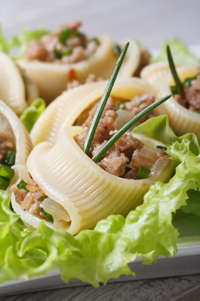 Pasta lumakoni stuffed meat vertical macro — Stock Photo, Image