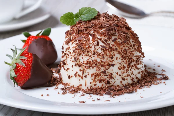 Panna cotta with dark chocolate and strawberries close-up — Stock Photo, Image