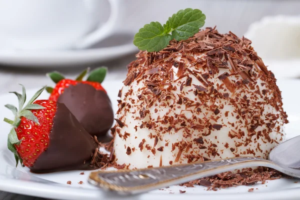 Strawberry in chocolate and dessert panna cotta on a plate — Stock Photo, Image