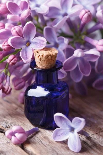 Extract from the fragrant lilac flowers close up on the table — Stock Photo, Image