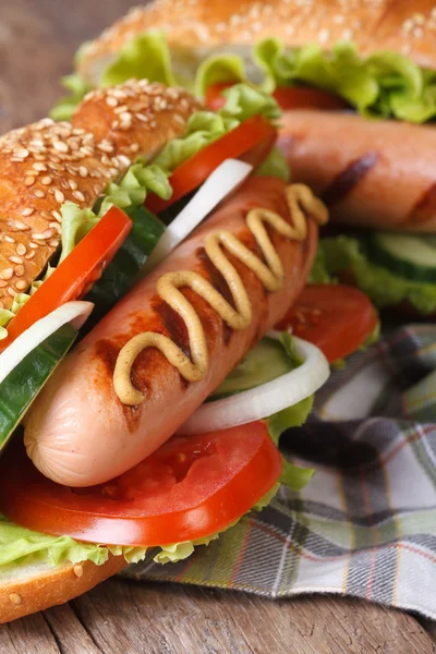 Cachorro quente em um pão com gergelim, salsicha e legumes — Fotografia de Stock