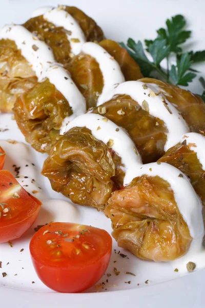 Cabbage rolls with sour cream macro. Vertical — Stock Photo, Image