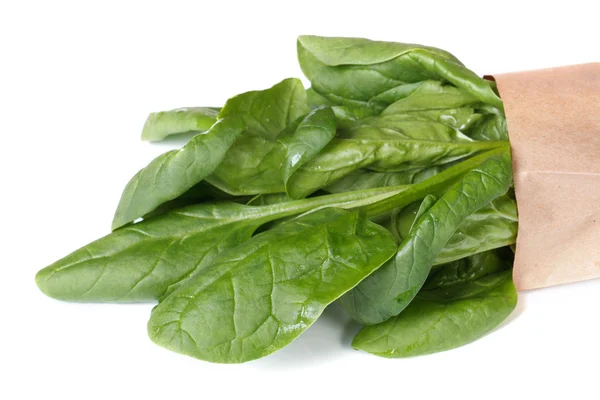 Fresh spinach in paper packing isolated on a white — Stock Photo, Image