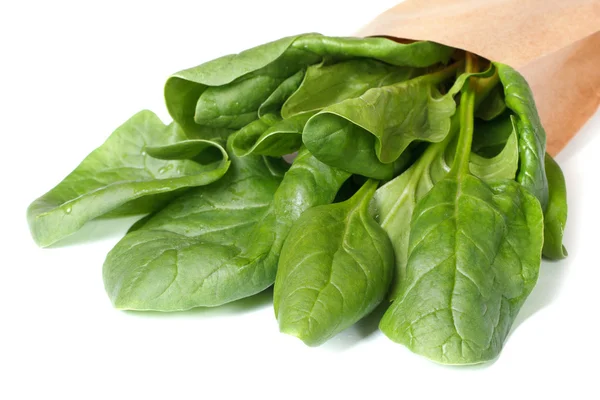 Spinach leaves in paper packing isolated on a white — Stock Photo, Image