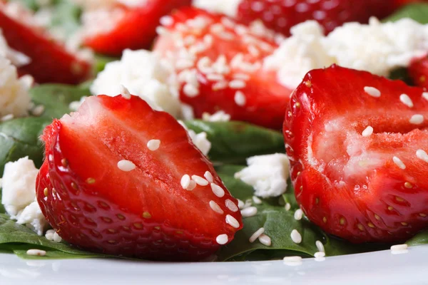 Strawberry closeup in vitamin salad with spinach. — Stock Photo, Image