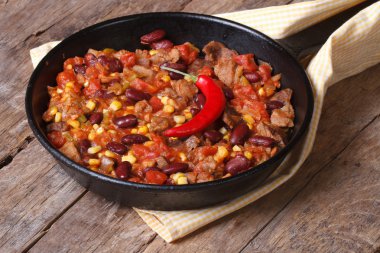 Mexican food is chili con carne in a frying pan 